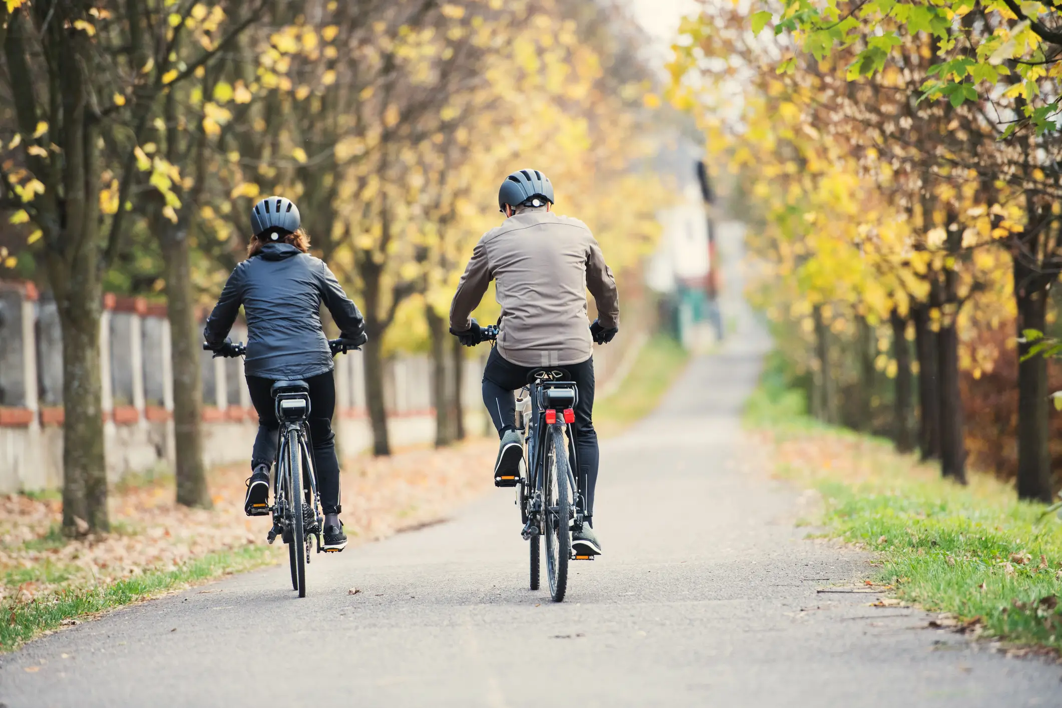 two people riding ebikes on a cycle path