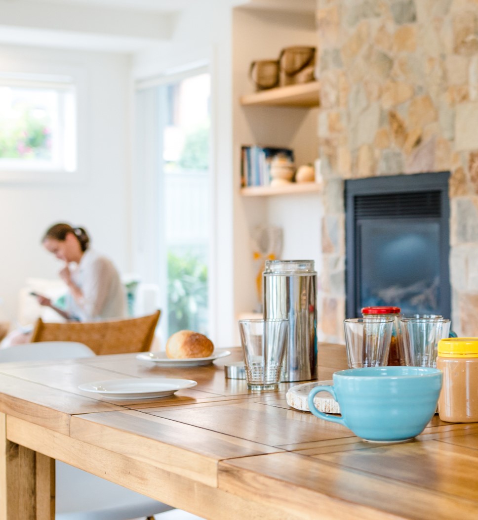 A coffee table in a quiet cafe with a woman sat in the background