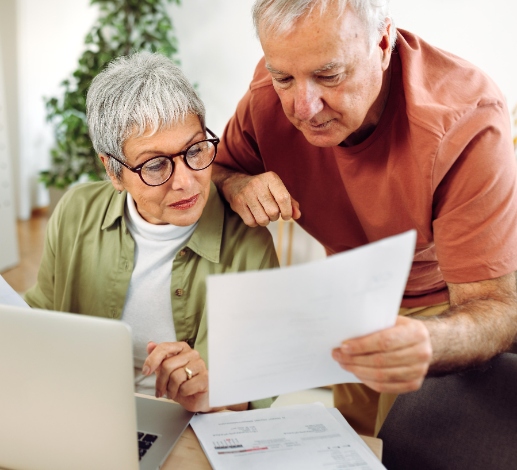 senior couple looking at paperwork bills