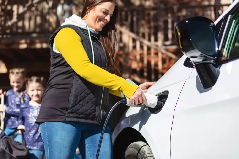 woman charging an electric car